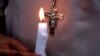 FILE - A Pakistani nun holds a candle during a vigil for victims of a deadly suicide bombing in a park, March 28, 2016, in Lahore. Pakistan's prime minister has vowed to eliminate perpetrators of mass terror attacks.