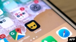 This from March 27, 2019, shows the Grindr icon on a phone. This week, the Committee for Investment in the United States reportedly directed Beijing Kunlun Tech to divest itself of Grindr, a gay dating app, because of concern the data it collects could be used for blackmail.