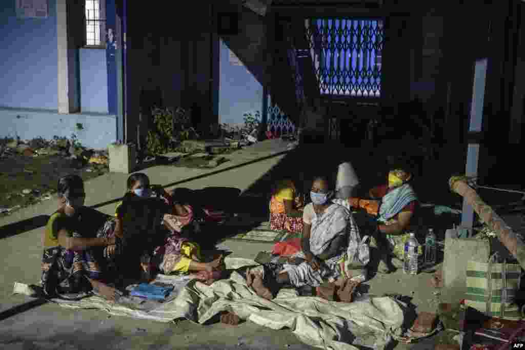 People wait for a coronavirus vaccine at the North Bengal Medical college and hospital on the outskirts of Siliguri, India.