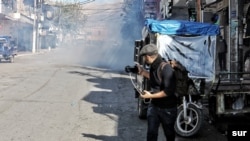 Rebaz Majeed takes photos on a street in Sulaymaniyah while covering anti-government protests on Dec. 3, 2020. (Courtesy, Hama Sur)