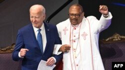 US President Joe Biden (L) stands with Bishop Ernest Morris, Sr. during a church service and campaign event at Mount Airy Church of God in Christ in Philadelphia, Pennsylvania, on July 7, 2024.