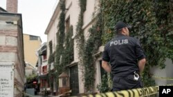 A police officer stands watch after the body of James Le Mesurier, a former British army officer who helped found the White Helmets volunteer organization in Syria, was found in Istanbul, Turkey, Nov. 11, 2019. 