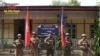 FILE - This photo released by the Arakan Army shows members of the Arakan Army posing in front of the captured district police office in Ann township, Rakhine state, Myanmar, Nov. 29, 2024. 