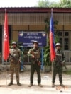 FILE - This photo released by the Arakan Army shows members of the Arakan Army posing in front of the captured district police office in Ann township, Rakhine state, Myanmar, Nov. 29, 2024. 