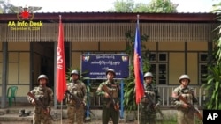 FILE - This photo released by the Arakan Army shows members of the Arakan Army posing in front of the captured district police office in Ann township, Rakhine state, Myanmar, Nov. 29, 2024. 