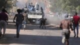 FILE: Sudanese confront the police during a protest against the military coup that ousted government last month, in Khartoum, Sudan. Taken Wednesday, Nov. 17, 2021