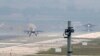 FILE - Turkish Air Force fighter planes land at Incirlik Air Base, on the outskirts of the city of Adana, southern Turkey, Thursday, July 30, 2015.