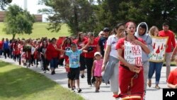 Miranda Muehl, of Mustang, Okla., marches during a march to call for justice for missing and murdered indigenous women Friday, June 14, 2019, at the Cheyenne and Arapaho Tribes of Oklahoma in Concho,…