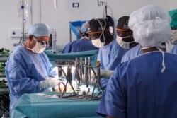 FILE - Doctors perform open-heart surgery at a hospital in Bamako, Mali, Sept. 10, 2018.