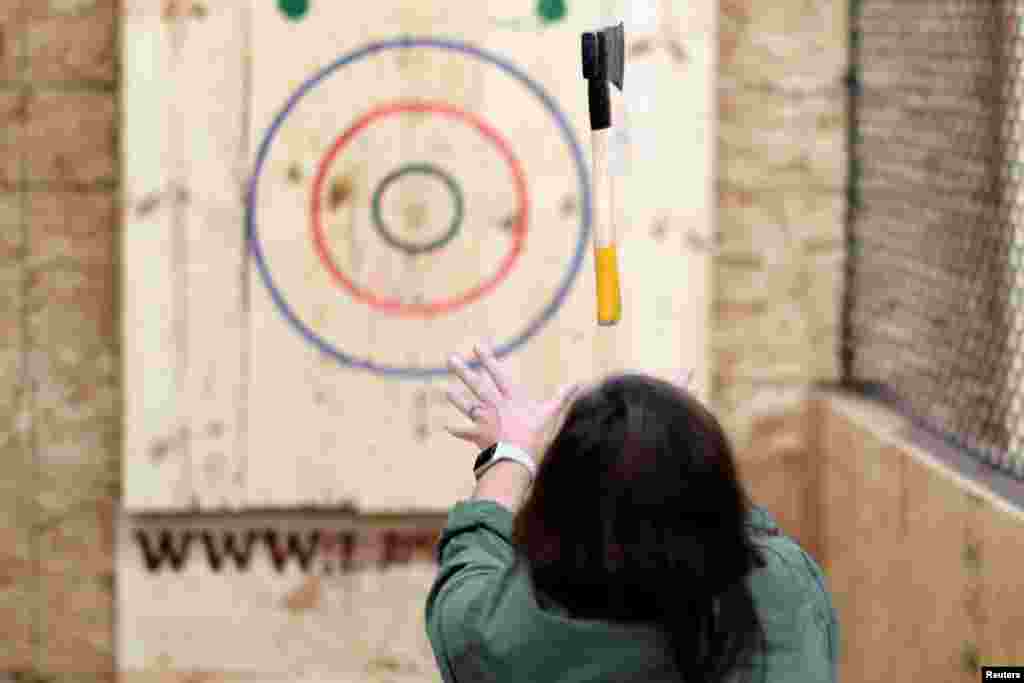 Teri Watson participates in axe throwing, a sport that started in the Canadian backwoods and is growing in popularity in U.S. cities, at LA Ax in North Hollywood, Los Angeles, California.