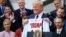 President Donald Trump shows off a Red Sox jersey presented to him during a ceremony welcoming the Boston Red Sox — the 2018 World Series champions — to the White House, May 9, 2019, in Washington.