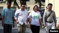 Panupong "Mike Rayong" Jadnok, Parit "Penguin" Chiwarak, Panusaya "Rung" Sithijirawattanakul and Arnon Nampa, a rights lawyer and protest leader arrive to report themselves to police summons at a police station in Bangkok, Thailand, Nov. 30, 2020. 