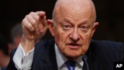 FILE - In this May 8, 2017, file photo, former National Intelligence Director James Clapper testifies on Capitol Hill in Washington, before the Senate Judiciary subcommittee on crime and terrorism.