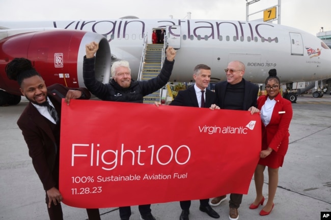 Virgin Atlantic Founder, Sir Richard Branson, UK Transport Secretary Mark Harper, and CEO, Shai Weiss, celebrate arrival of Flight100 in NYC, Tuesday, Nov. 28, 2023 in New York. (Jason DeCrow/AP Images for Virgin Atlantic Airways Ltd)