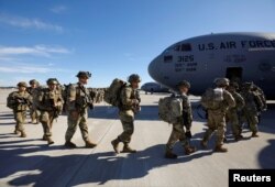 U.S. Army paratroopers of an immediate reaction force from the 2nd Battalion, 504th Parachute Infantry Regiment, 1st Brigade Combat Team, 82nd Airborne Division, board their C-17 aircraft at Fort Bragg, N.C., Jan. 1, 2020.