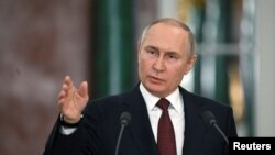 Russian President Putin attends a news conference in Moscow