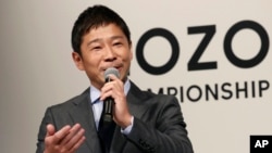 FILE - Zozo Chief Executive Yusaku Maezawa speaks during a press conference on the PGA Tour in Tokyo, Nov. 20, 2018. 