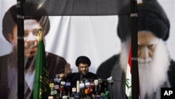 Shi'ite cleric Moqtada al-Sadr gestures during his first public appearance since returning from nearly four years of self-imposed exile in Najaf, south of Baghdad, Iraq, 08 Jan 2011