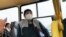 Separatist war prisoners, some of them wearing face masks to protect against coronavirus, sit in a bus after they were exchanged near the checkpoint Horlivka, eastern Ukraine, April 16, 2020.