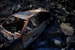 A vehicle was burned in a wildfire on the outskirts of Jerusalem, Aug. 17, 2021.