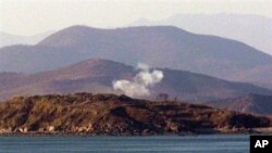 Smoke rises on the Yeonpyeong Island, South Korea, 26 Nov 2010