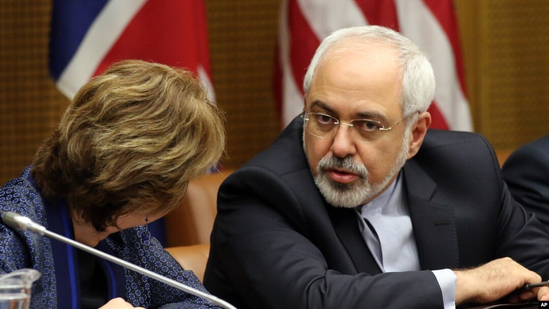 European foreign policy chief Catherine, Ashton, left, and Iranian Foreign Minister Mohammad Javad Zarif, right, wait for the start of closed-door nuclear talks in Vienna, Austria, Tuesday, June 17, 2014
