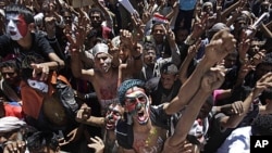 Yemeni protesters, their faces colored with their national flag and Arabic writing that reads "stop killing the innocent", chant anti-government slogans during a demonstration demanding the resignation of President Ali Abdullah Saleh in Sana'a, October 11