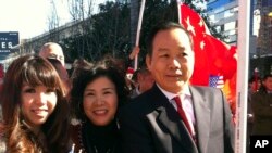 FILE - American businessman Vincent Wu, right, poses for a photo with his wife Yip Lai Fong, center, and daughter Anna Wu as they wait to welcome China's then-Vice President Xi Jinping on his visit to Los Angeles, Calif.