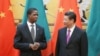 FILE - Chinese President Xi Jinping, right, talks with Zambia's President Edgar Chagwa Lungu, during a signing ceremony at the Great Hall of the People Monday, March 30, 2015 in Beijing, China. 