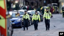  British police officers walk within a cordoned off area after an attack in the London Bridge area of London, June 4, 2017. Saturday night attackers killed several people in a series of vehicle and knife attacks before police shot them dead.