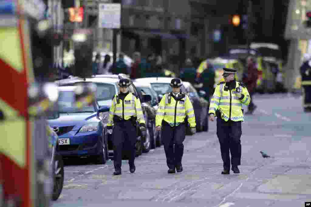 British police officers walk within a cordoned off area after an attack in the London Bridge area of London, June 4, 2017. Saturday night attackers killed several people in a series of vehicle and knife attacks before police shot them dead.