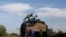 Central American migrants, moving in a caravan through Mexico, travel on a wagon of a freight train after stopping it on the rail line, in Michoacan state, Mexico, April 17, 2018. 