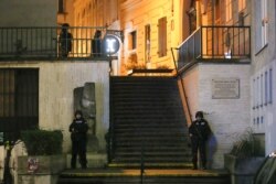 Police officers stay in position at stairs named "Theodor Herzl Stiege" near a synagogue after gunshots were heard, in Vienna, November 2, 2020.