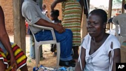 Refugee women in Tuzon, Liberia gather and sell produce to make money to feed their children