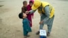 A health worker administers a polio vaccine to a child in a neighborhood of Lahore, Pakistan, Nov. 27, 2023. As the global community marks World Polio Day on October 24, Pakistan faces 40 cases so far this year, compared to six in 2023.