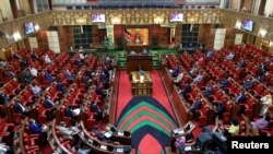 FILE - Kenyan members of parliament maintain social distance amid the COVID-19 pandemic inside the Parliament buildings in Nairobi, June 10, 2021. 