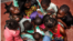 Children gather around a table at SOS Children's Villages Bangui. (Photo by Till Müllenmeister)