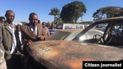 Nelson Chamisa inspecting a vehicle belonging to his party set on fire by unknown arsonists.