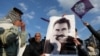 FILE - A demonstrator holds a picture of jailed Kurdish militant leader Abdullah Ocalan during a rally in Diyarbakir, Turkey, Feb. 27, 2025. The Peoples' Equality and Democracy Party has announced a new roadmap to peace following Ocalan's call for his group to disarm. 