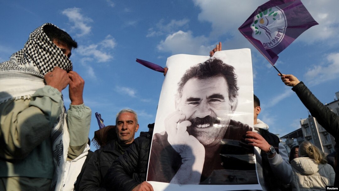 FILE - A demonstrator holds a picture of jailed Kurdish militant leader Abdullah Ocalan during a rally in Diyarbakir, Turkey, Feb. 27, 2025. The Peoples' Equality and Democracy Party has announced a new roadmap to peace following Ocalan's call for his group to disarm.