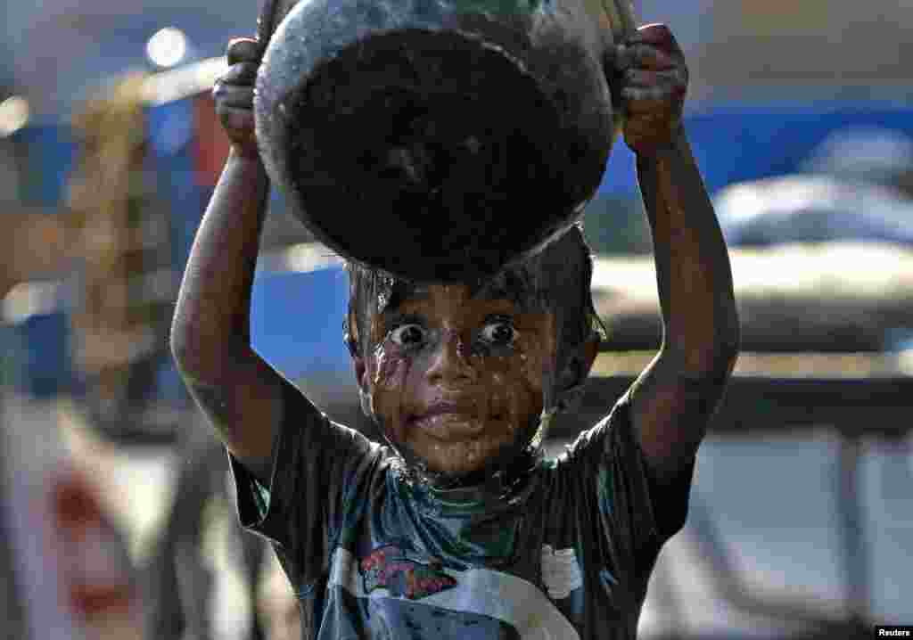 A boy takes a bath along a pavement in the southern Indian city of Chennai. World Water Day is celebrated on March 22.