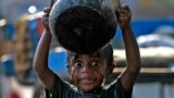 A boy takes a bath along a pavement in the southern Indian city of Chennai. World Water Day is celebrated on March 22.