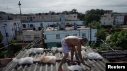 Roelvis Matos, 46, prepares the roof of his home ahead of the arrival of the Storm Eta in Havana, Cuba, Nov. 7, 2020. 