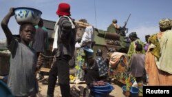 A French armored vehicle drives on a road next to the central market in Diabaly, Mali, January 23, 2013.