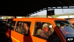 FILE - A taxi operator drives commuters in Pretoria, South Africa, June 1, 2020. Taxi drivers in the country's financial hub Gauteng went on strike to demand more goverment support during the coronavirus pandemic.