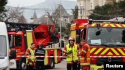 French firefighters and rescue forces stand near the entrance of the Russian consulate in Marseille after the consul general confirmed there had been an explosion, in Marseille, France, Feb. 24, 2025. 