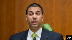 FILE - Federal Communication Commission Commissioner Ajit Pai speaks during a hearing in Washington.