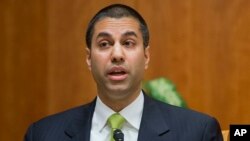 FILE - Federal Communication Commission Commissioner Ajit Pai speaks during a hearing in Washington.