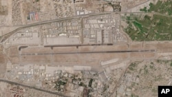 In this satellite photo released by Planet Labs Inc., Kabul's international airport is seen as an evacuation flight taxis to the military side of the airport in Kabul, Afghanistan, Thursday, Aug. 26, 2021.