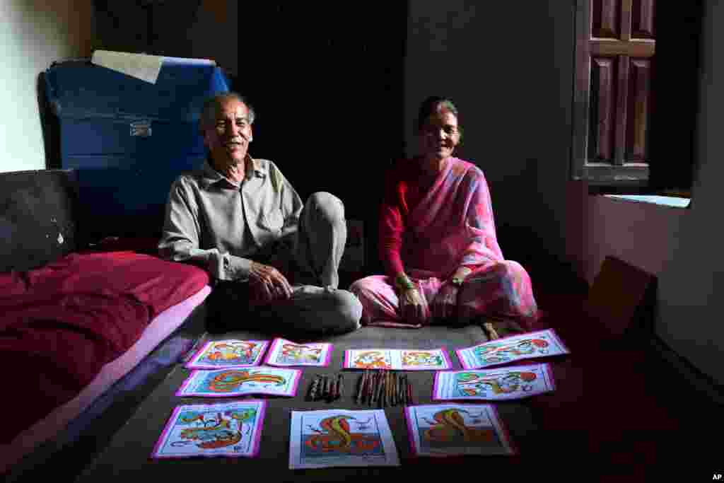 Chitrakar couple Tej Kumari and Purna, left, pose for photographs at their residence in Bhaktapur, Nepal, July 31, 2019.